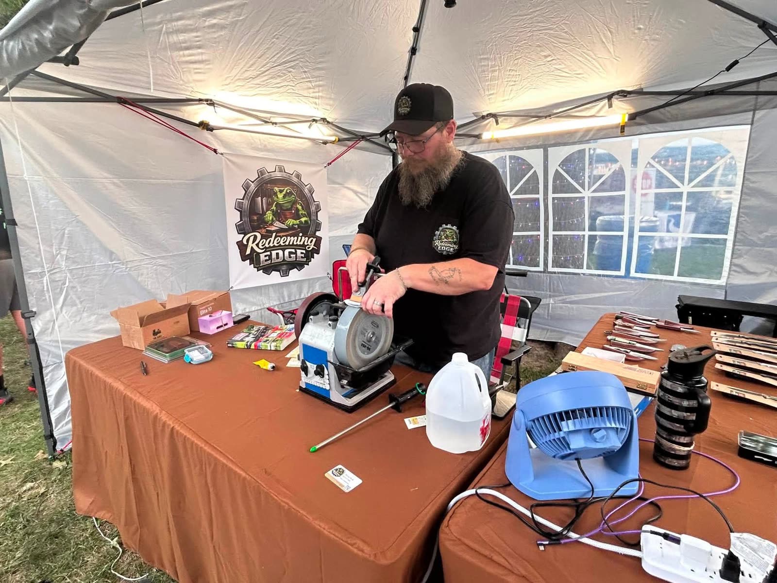 David Peck, owner of Redeeming Edge, sharpening on a Tormek T8 at the Redeeming Edge booth