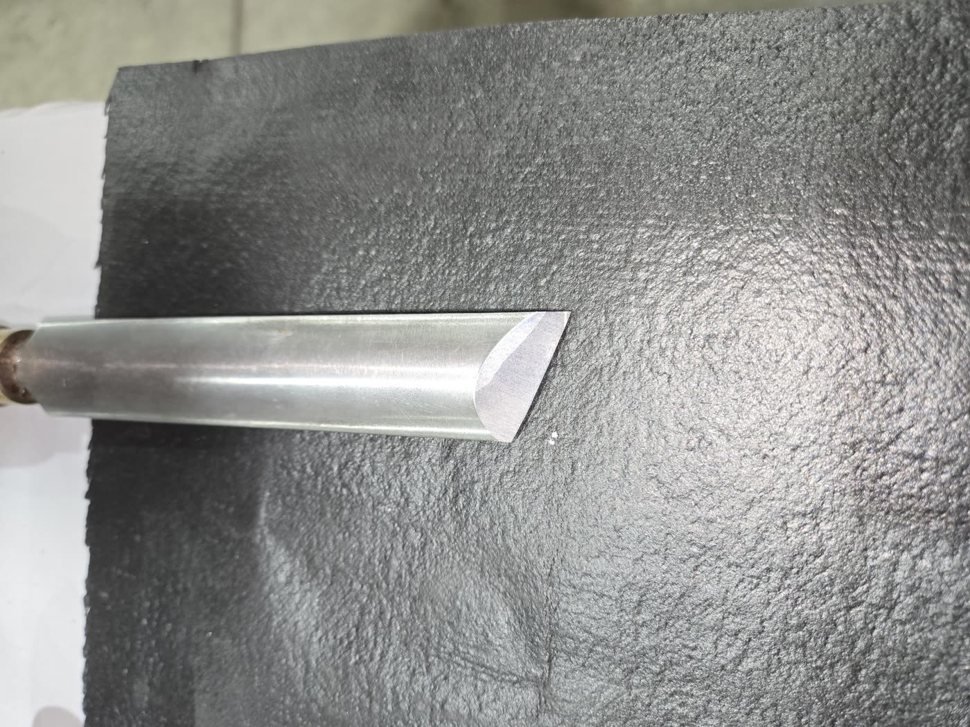 Close-up of a freshly sharpened woodturning gouge with a clean polished bevel